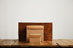 Wine box and cardboard boxes on wooden table