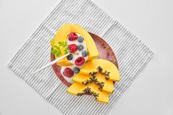 Portion of yummy papaya bowl with berries