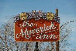 Daytime view of a neon sign for the Maverick Inn in Alpine, Texas E47GO4