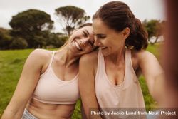 Close up of two smiling females relaxing after workout outdoors bEQRVb