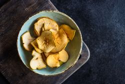 Top view of apple chips in rustic bowl