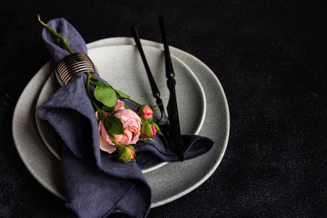 Flowers wrapped in navy napkin on grey plate