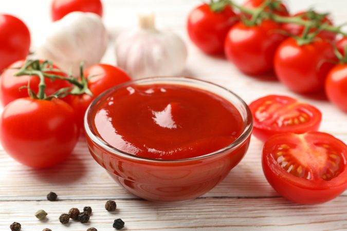 Composition with tomatoes on wooden background, close up