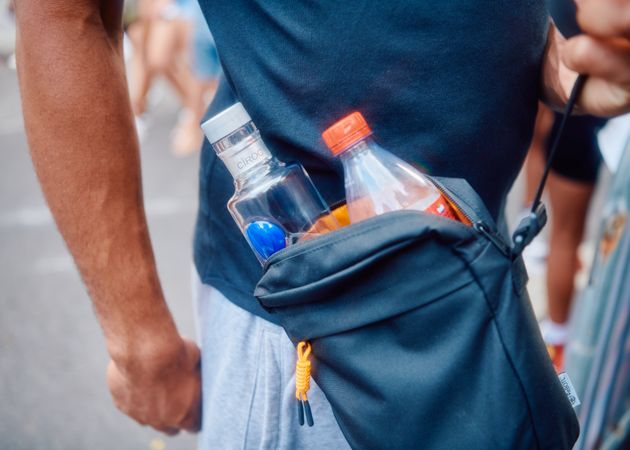 Small bag on man’s body with alcohol for street party