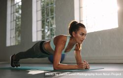 Fit young woman doing push ups at gym 0LdNoD