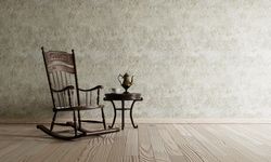 Minimal clean room with rocking chair and metal tea pot