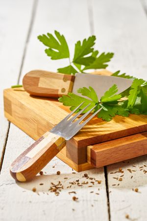 Parsley with knife on cutting board set