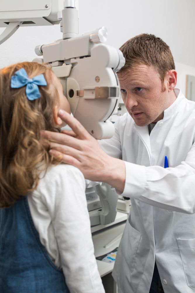 Optician testing a girl's eyes