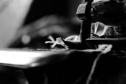 B&W side view of string through sewing machine needle