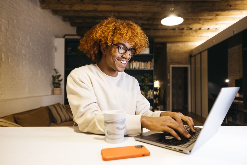 Young man using a laptop at home.