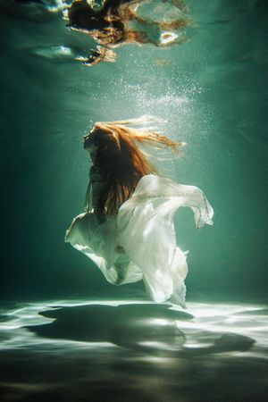 Underwater shot of woman wearing light dress