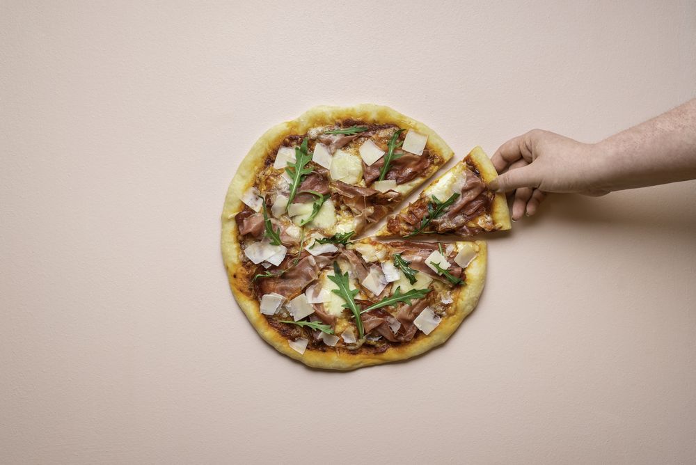 Pizza ham and cheese on pink background