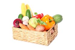 Wicker basket with vegetables isolated on blank background