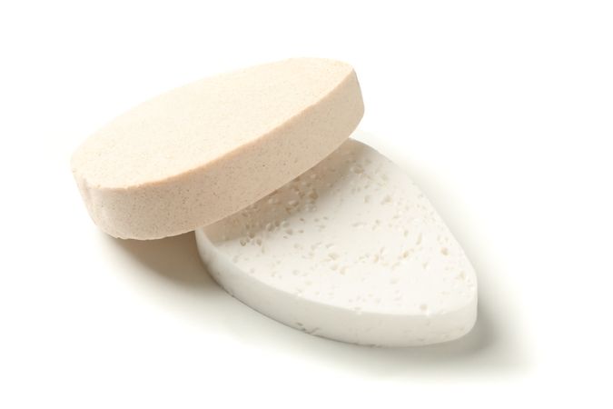 Bath sponges isolated on blank background, closeup