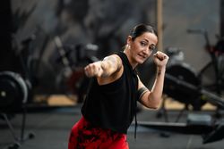 Expert female fighter training in the gym