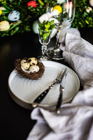 Decorative nest of speckled eggs on Easter table setting