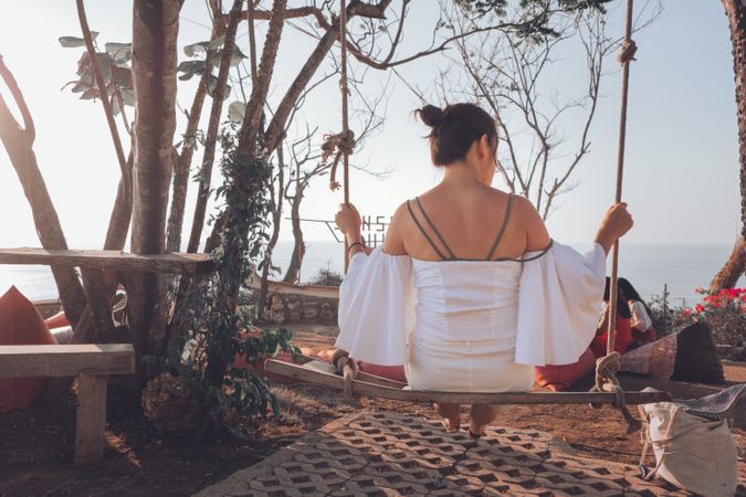 Young woman sitting on swing