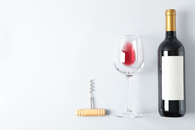 Flat lay composition with corkscrew, bottle and glass with wine, copy space