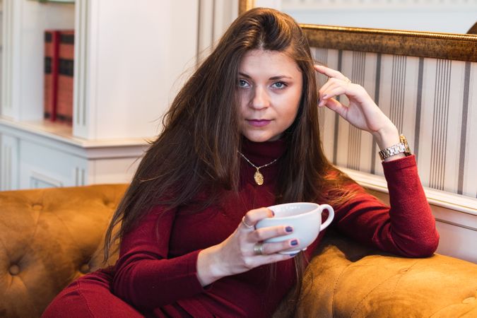 Woman with cup of coffee on the couch