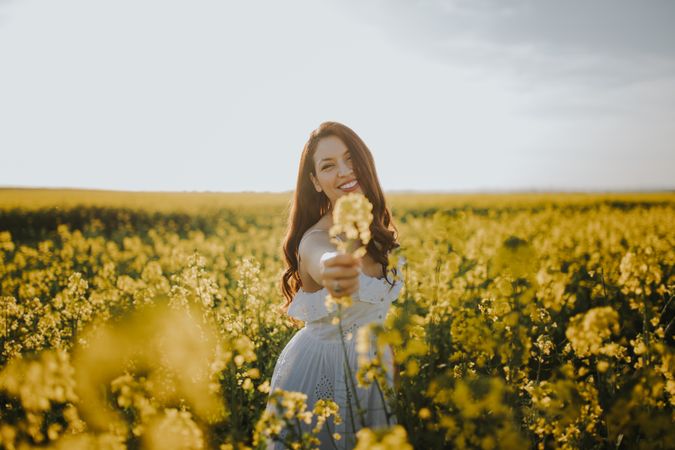 Woman with flowers in field