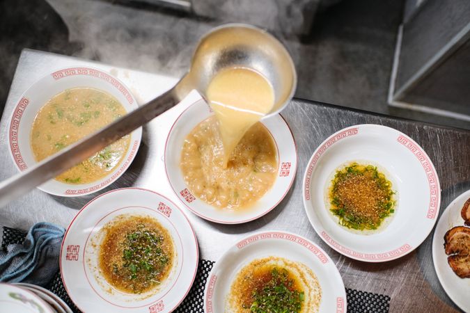 Process of serving delicious soup on table
