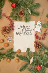 Christmas greeting written with a beautiful handmade letter with Christmas decorations and lights around.