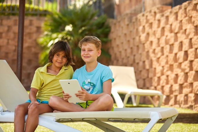 Boys using tablet in garden