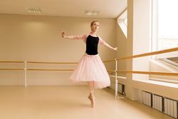 Ballet dancer spinning en pointe in well-lit dance studio