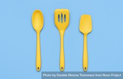 Yellow kitchenware set isolated on blue background above view 0L9zg5