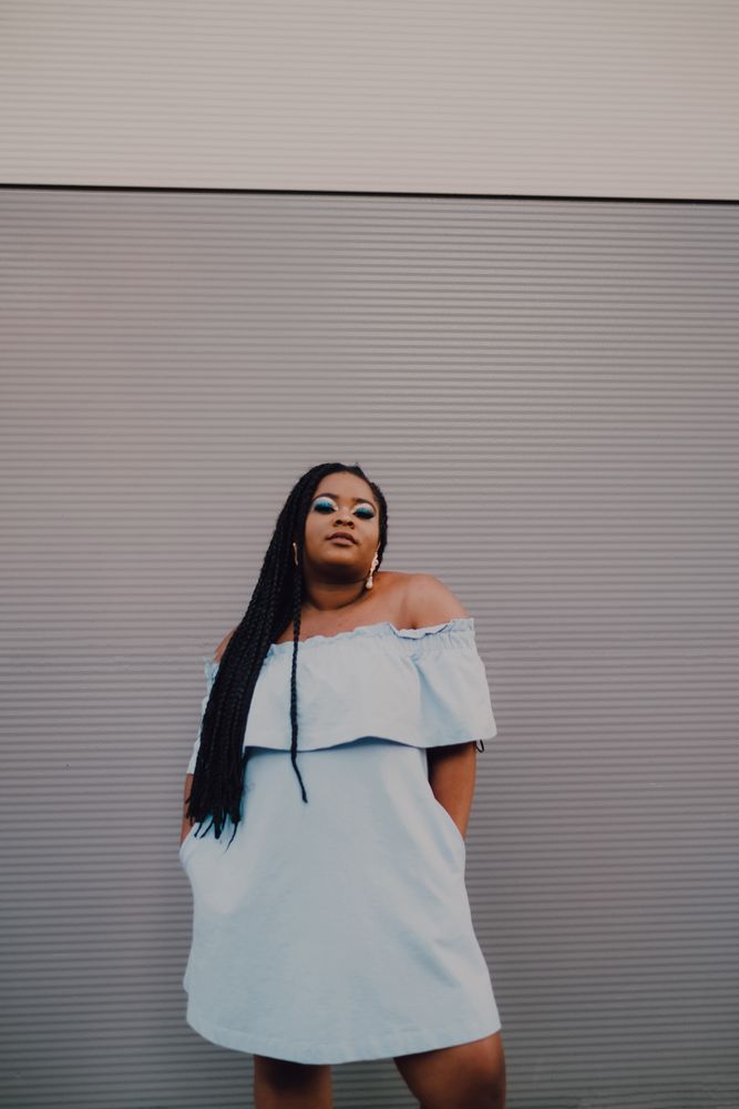 Content trendy Black woman on wall