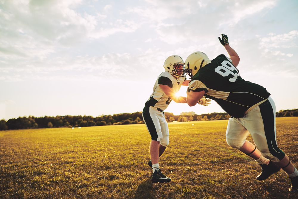 Two men practicing football drills