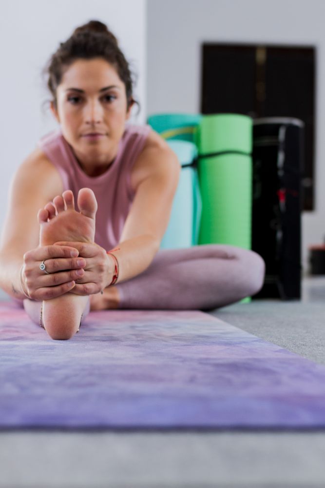pensive woman doing yoga indoors
