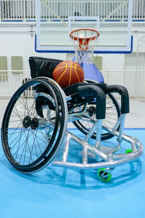 Basketball on wheelchair in an a basketball field