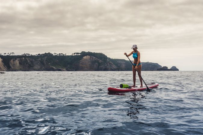 Woman on paddleboard floating in sea