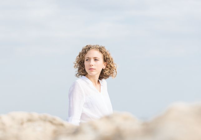 Young pensive woman and blue sky