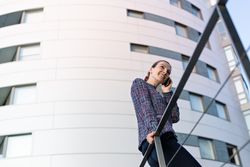 Smiling businesswoman answering phone call