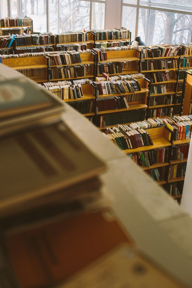 Brown wooden book shelves with books in library