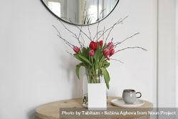 Vase of tulips on entry way table with mockup paper card 5rp6Zb