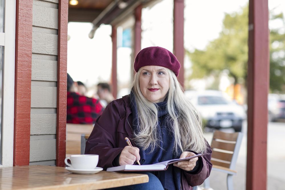 Woman taking a break while writing in her notebook