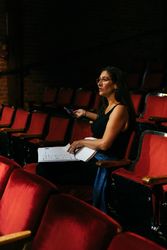 Female director giving feedback to actors on the stage
