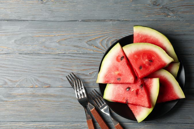 Composition with watermelon slices on gray wooden table. Summer fruit