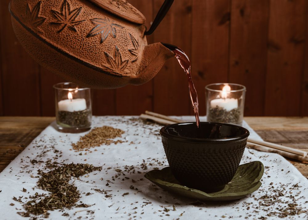 Aromatic tea dates and clay teapot on table