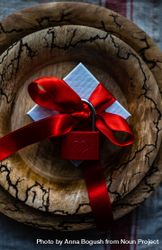 Rustic plate with ribbon wrapped present with red padlock bGRRgA