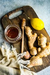 Raw ginger & lemon on wooden board