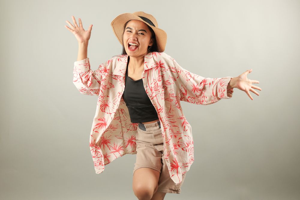 Positive Asian Female Tourist Wearing Summer Holiday Beach Shirt and Hat Feels Happiness