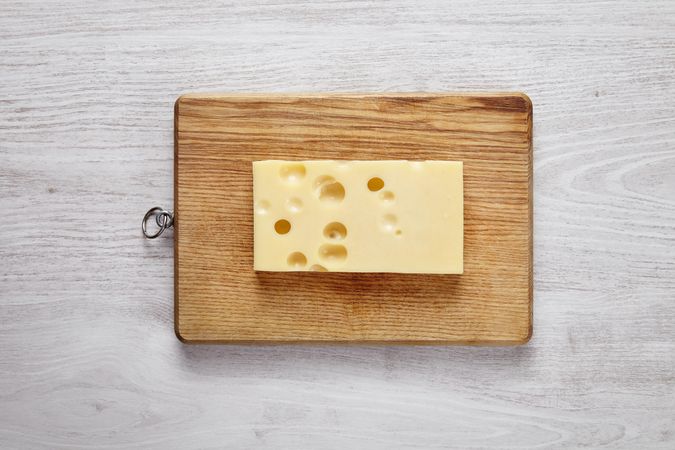 Swiss cheese on wooden board