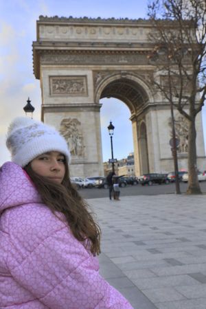 Girl standing against triumphal arch