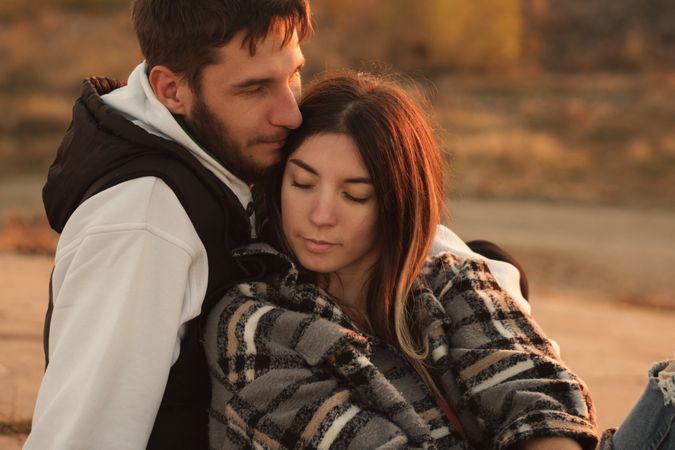 Couple sitting dusk countryside