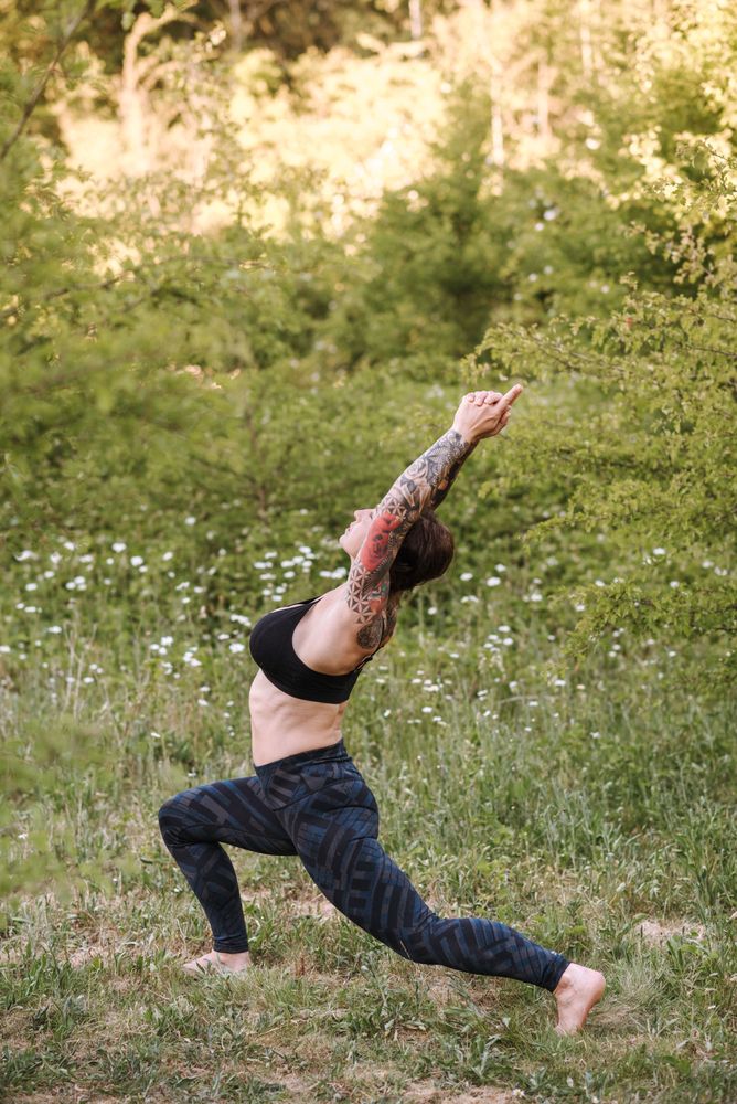 Woman standing on grass stretching