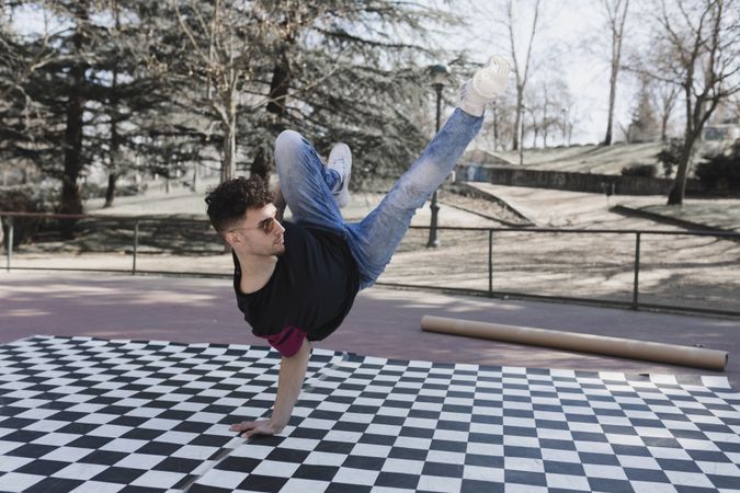 Man dancing break dance in park